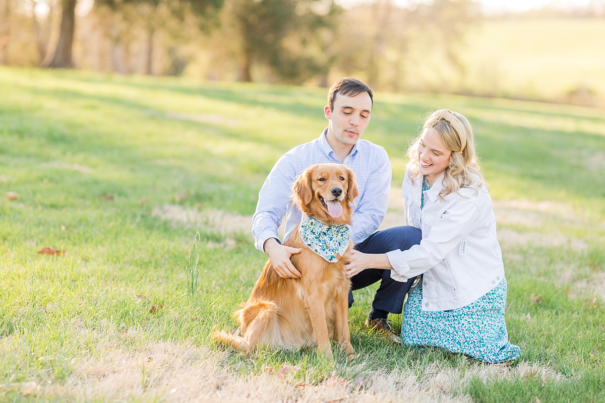 couple loving on their dog during engagement photos