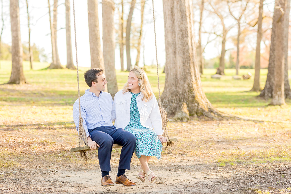 guy and girl swinging for engagement photo session